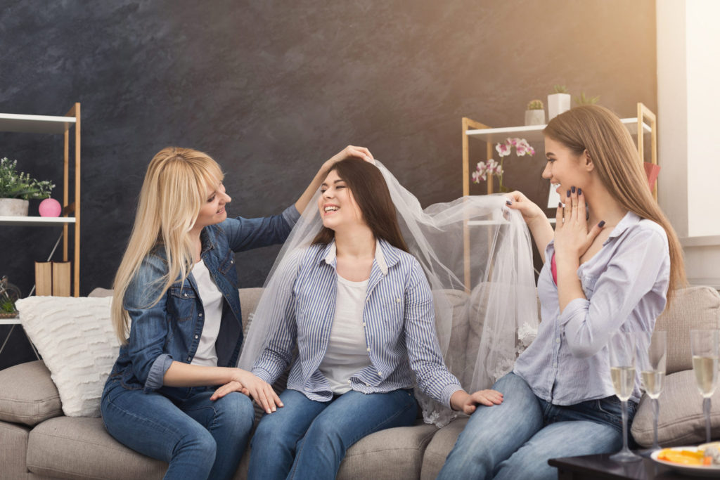 bride preparing for wedding with friends