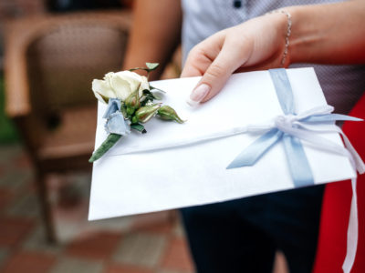 wedding invitation in hand