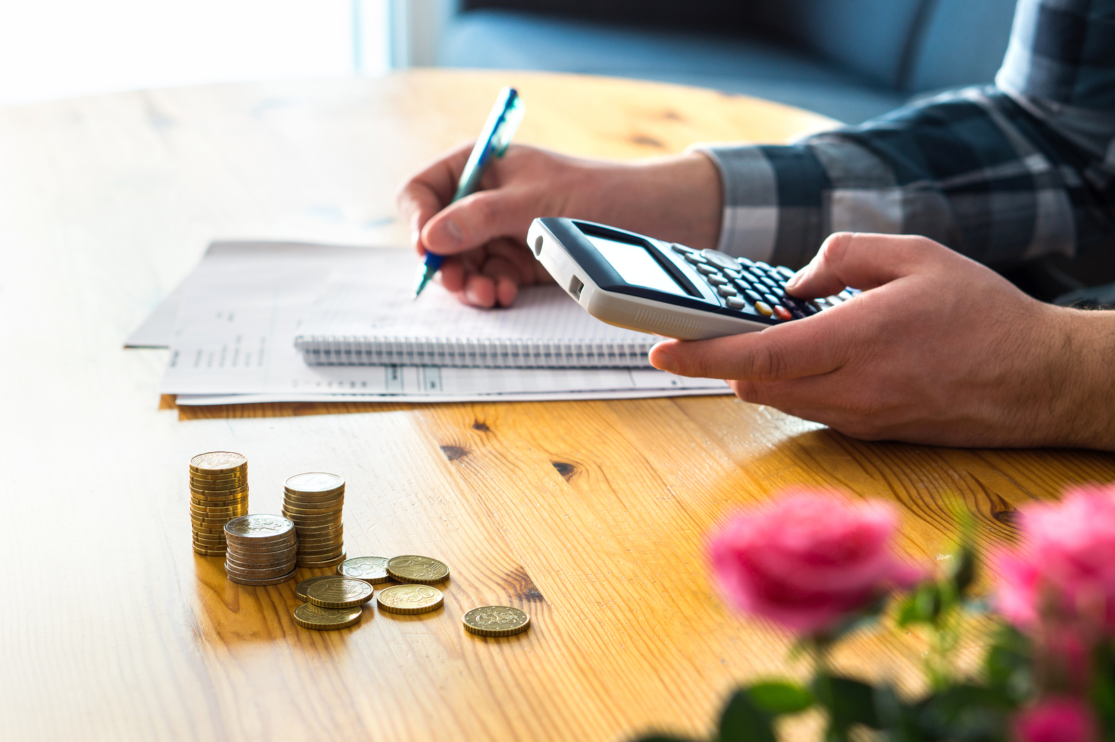 man using calculator to budget - planning a corporate event