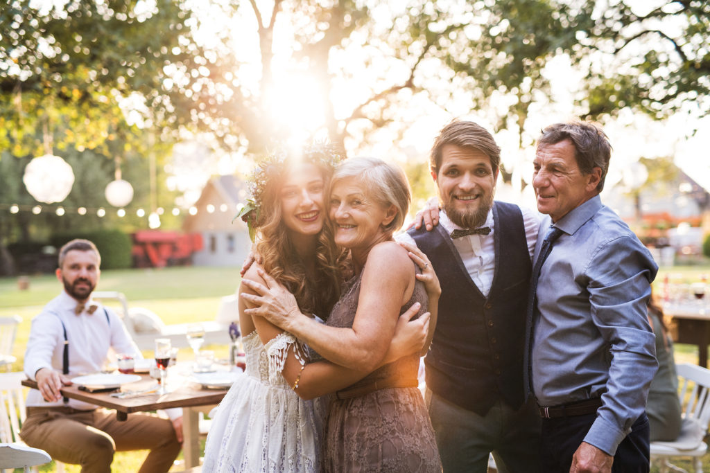 Wedding Guest List - Bride And Groom Outside With Family