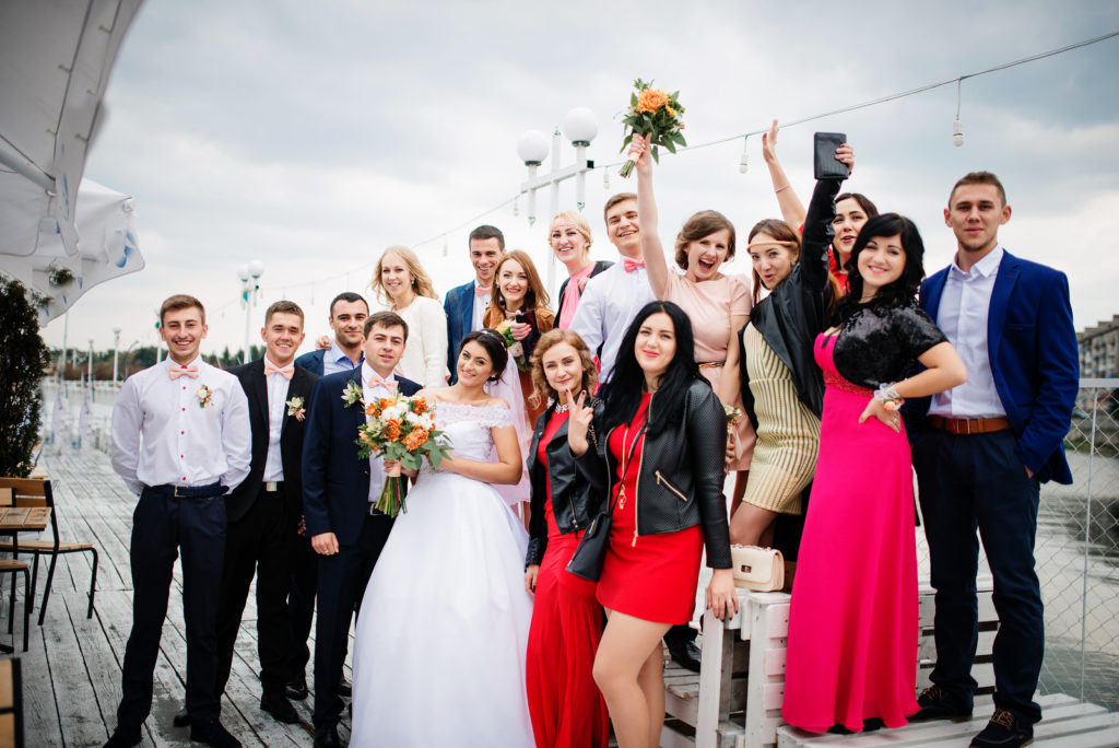 Wedding Guest List - Bride And Groom With Young Wedding Guests Outside