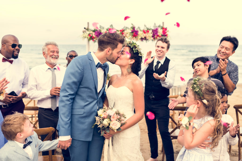 Wedding Guest List - Bride And Groom Kiss At The Altar