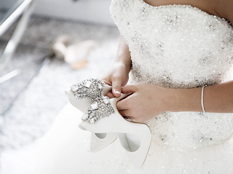 Online Wedding Shopping - Bride Holding Jeweled High Heels