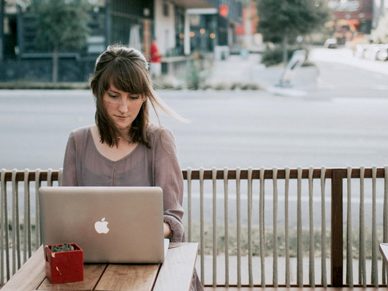 Online Wedding Shopping - Woman Sitting Outside Using Laptop