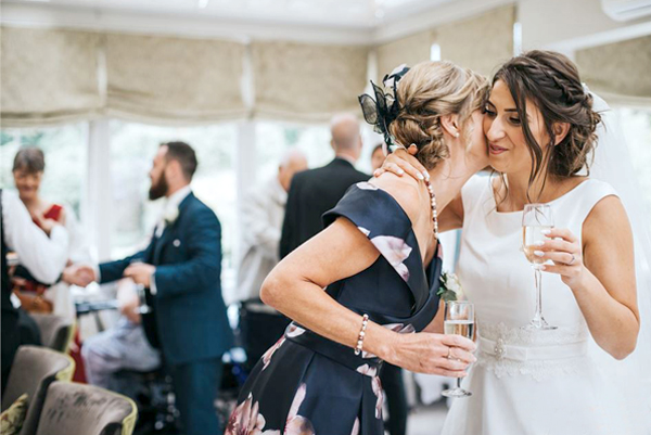 Wedding Guests Care About - Bride Hugging A Wedding Guest