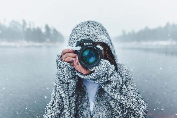 Wedding Guests Care About - Woman In Hooded Sweater In The Snow Taking A Photo With Nikon Camera