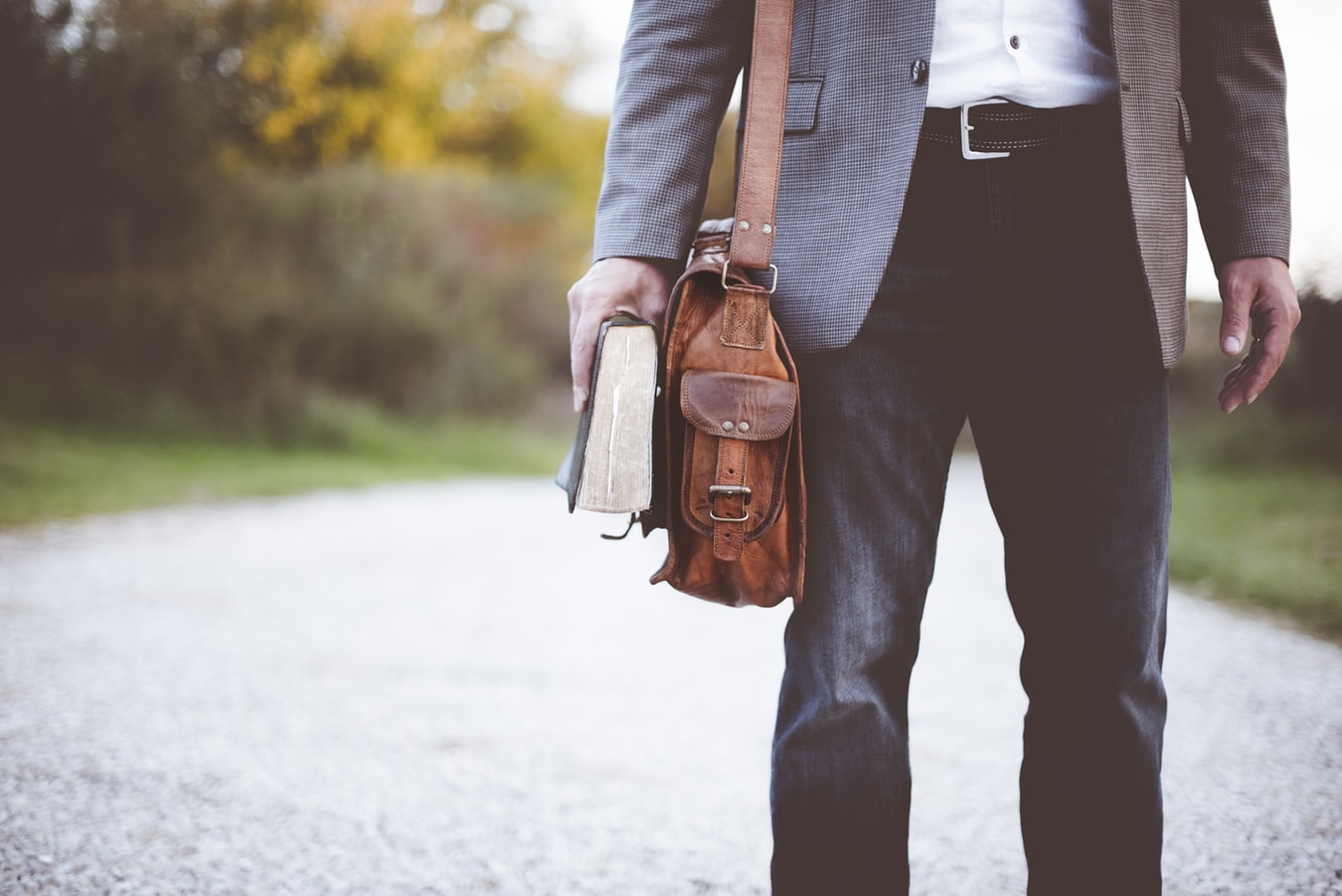 Wedding Planning Tips - Meet Officiant - Man Holding Satchel And Bible